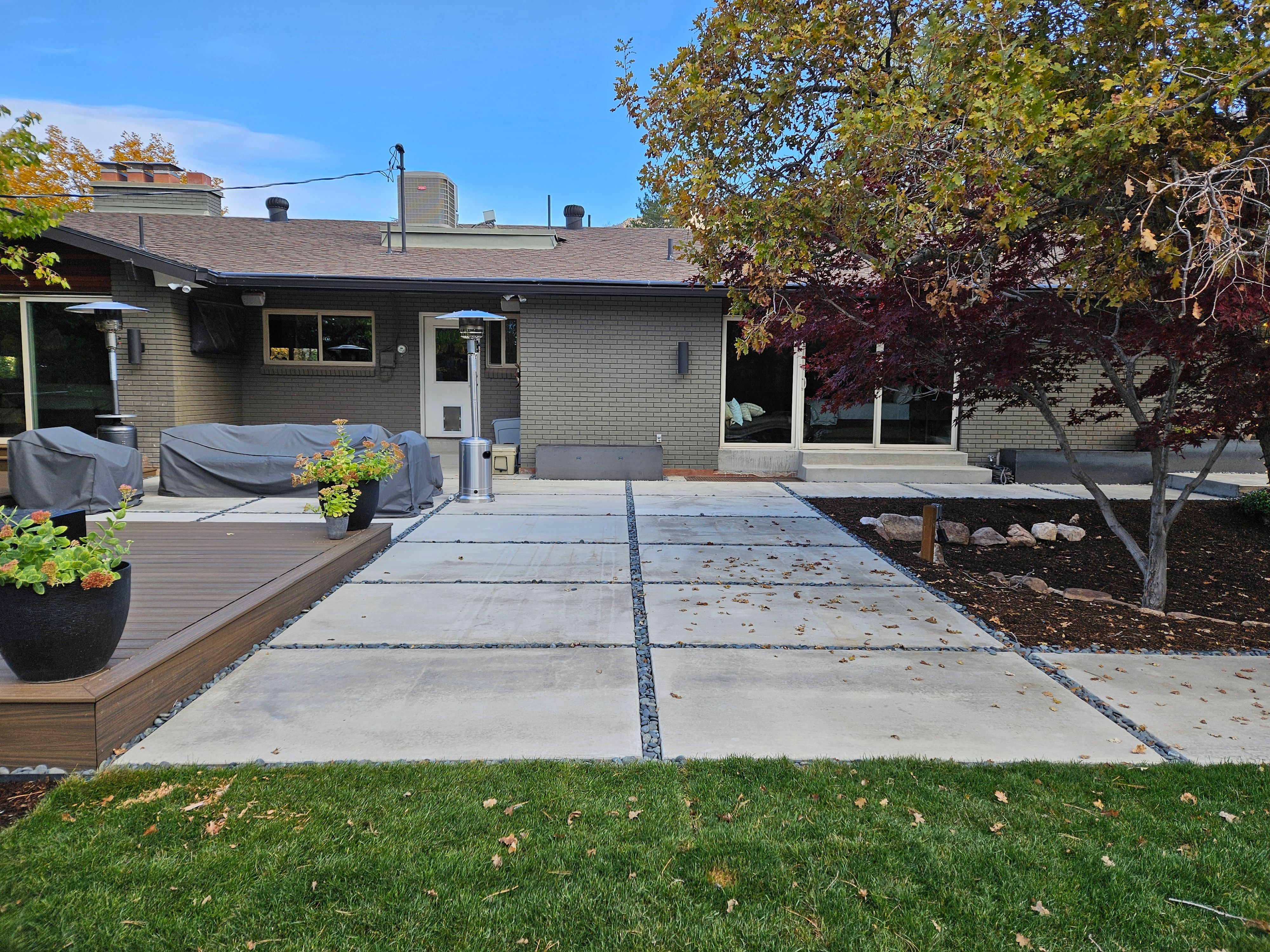 Modern concrete patio installation in Holladay backyard.