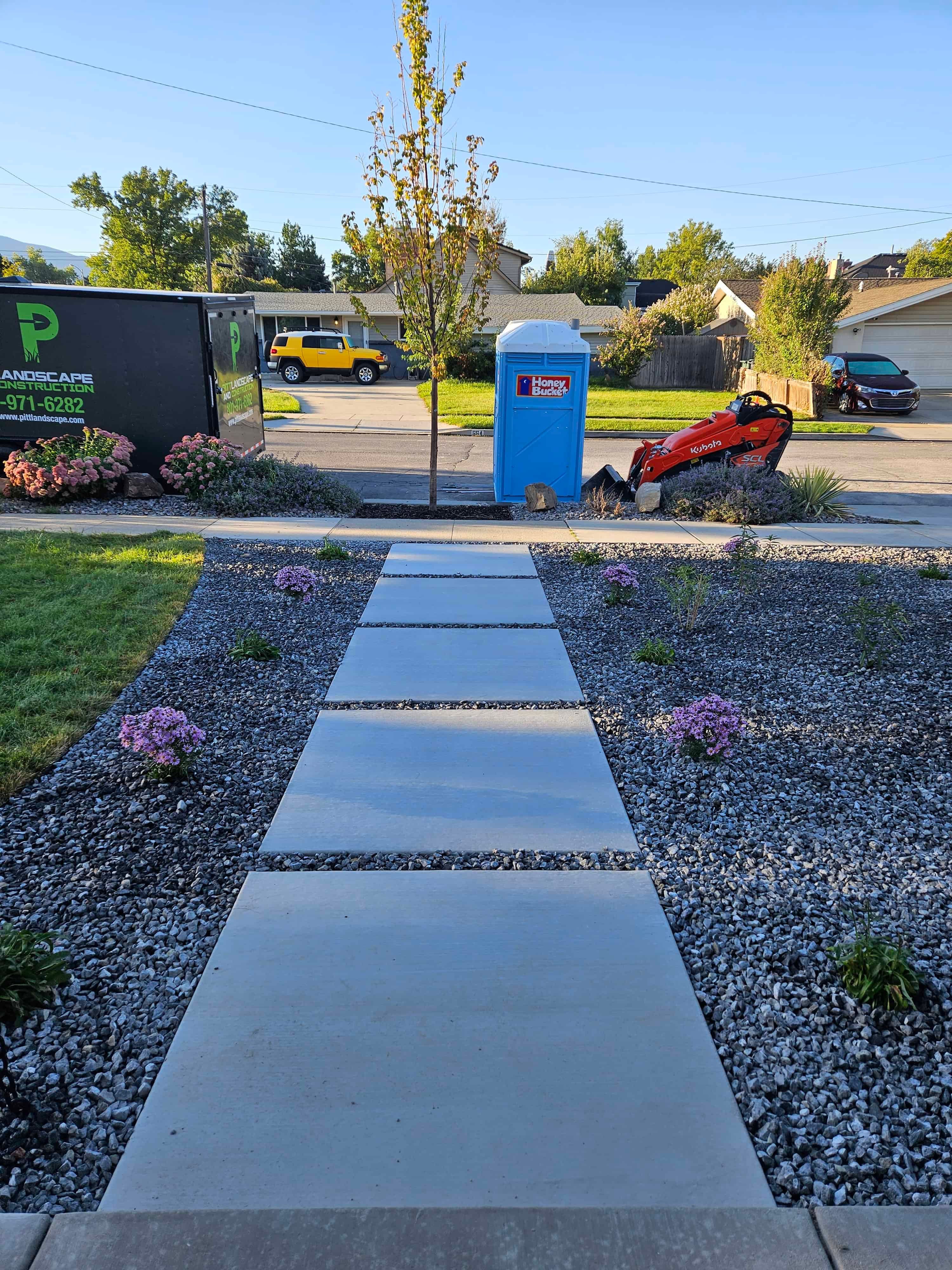 Modern concrete walkway in Murray, Utah connecting the front yard to the sidewalk.