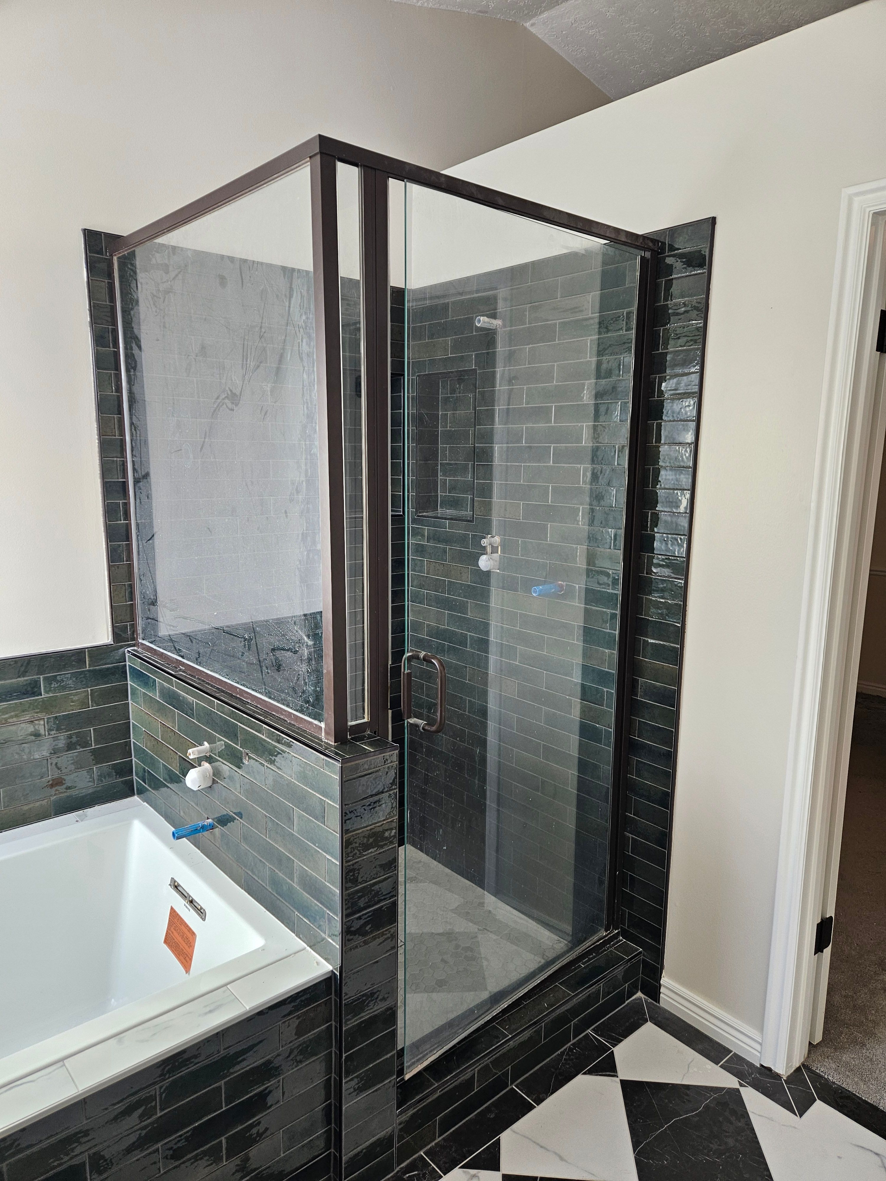 Finished shower tile with repurposed glass door installed in Murray, Utah bathroom remodel.