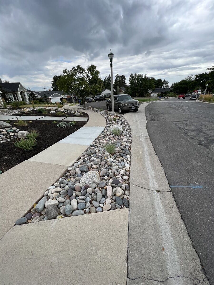 The xeriscaping design in Utah featuring sustainable gravel and mulch elements