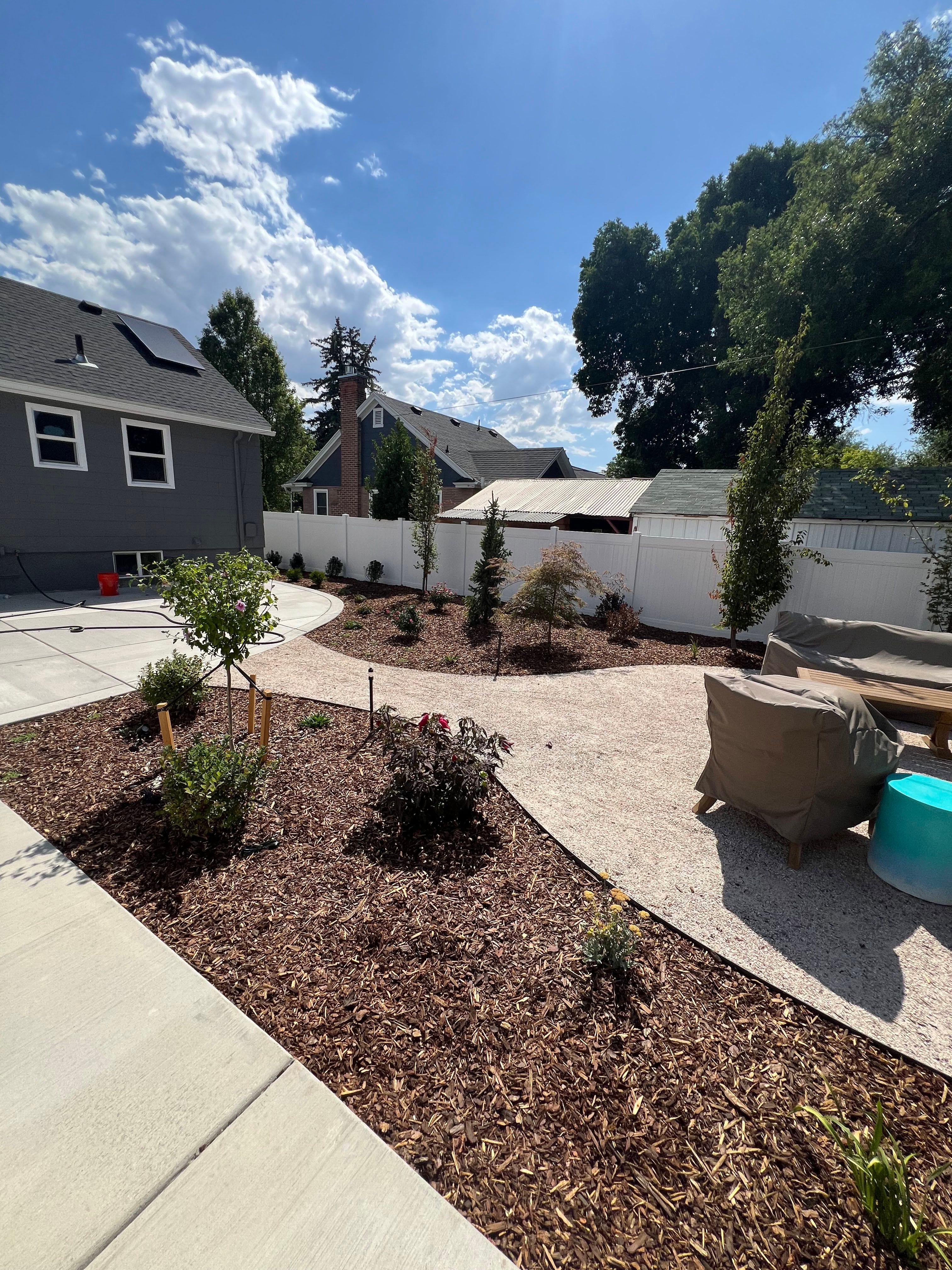 Millcreek xeriscape design with walkway, drought-tolerant plants, and natural bark mulch.