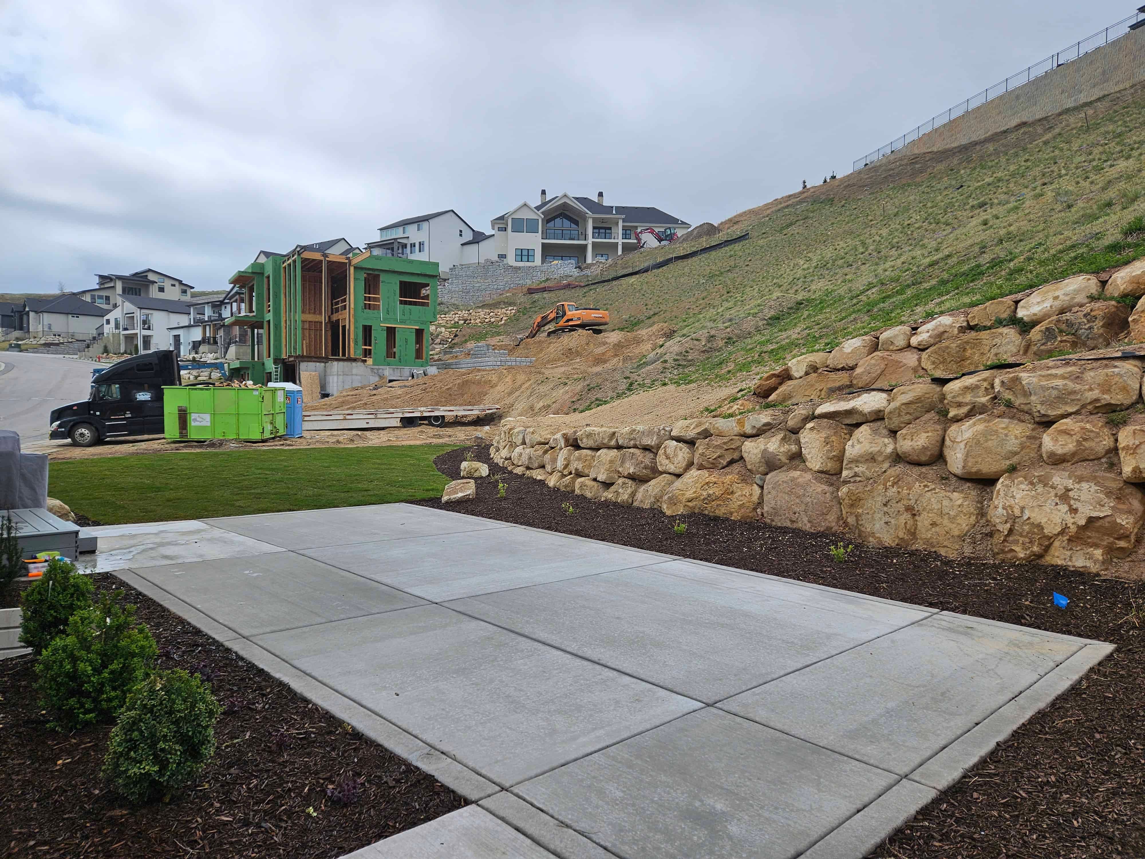 Backyard concrete patio installation in Lehi, Utah landscape project.