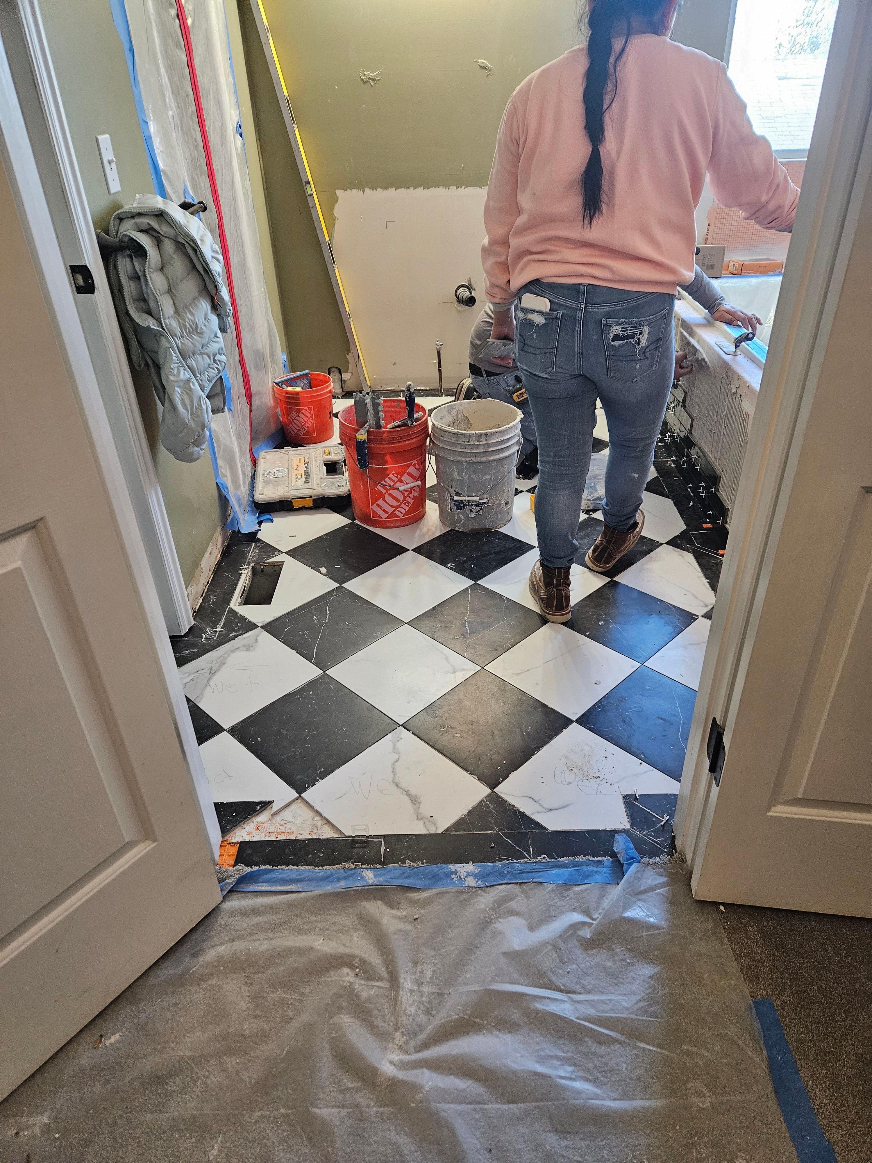 Main bathroom floor tile installation in progress in Murray, Utah remodel.