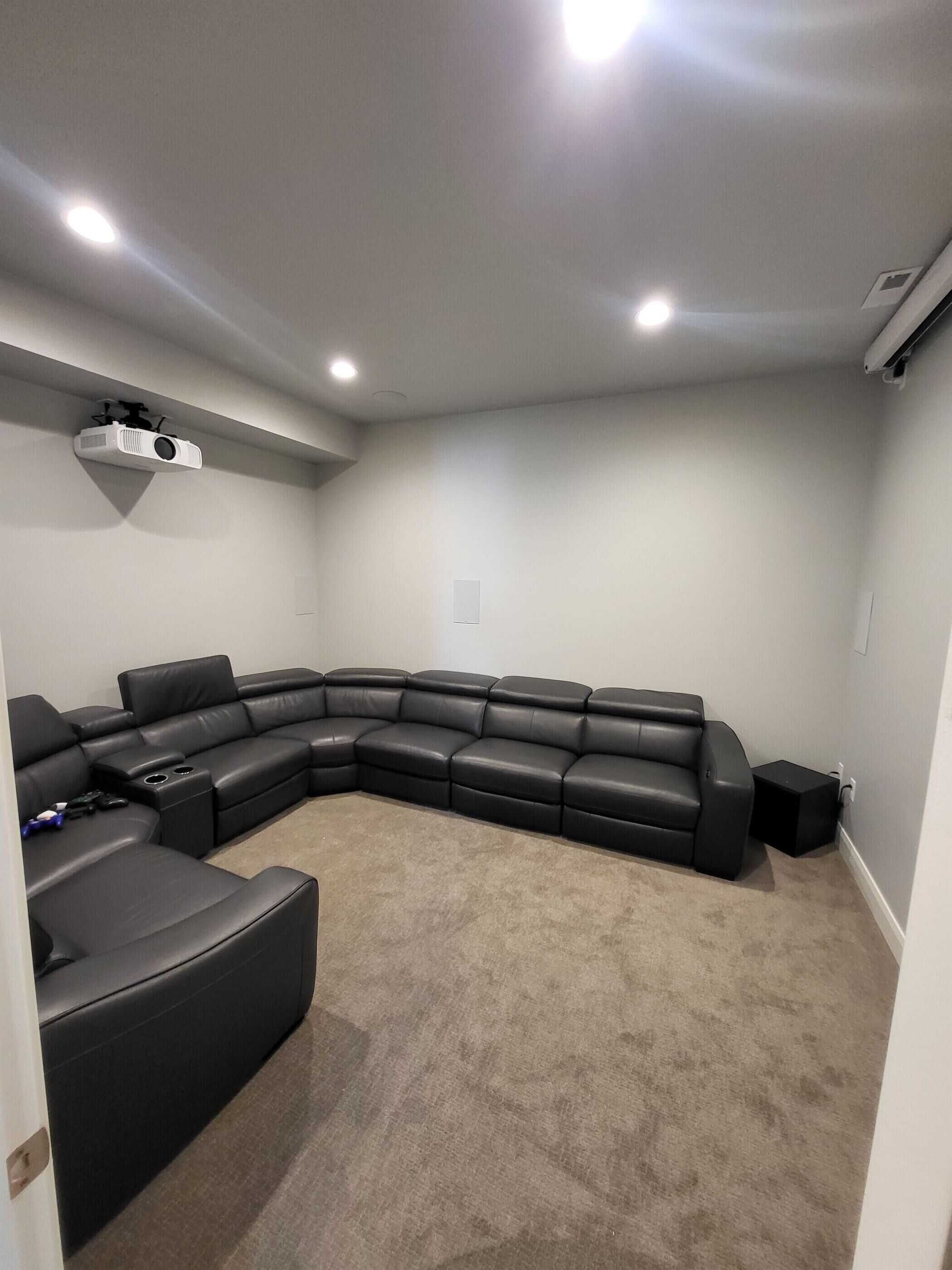 Family area with custom lighting and couch in a basement finishing project in Salt Lake City.