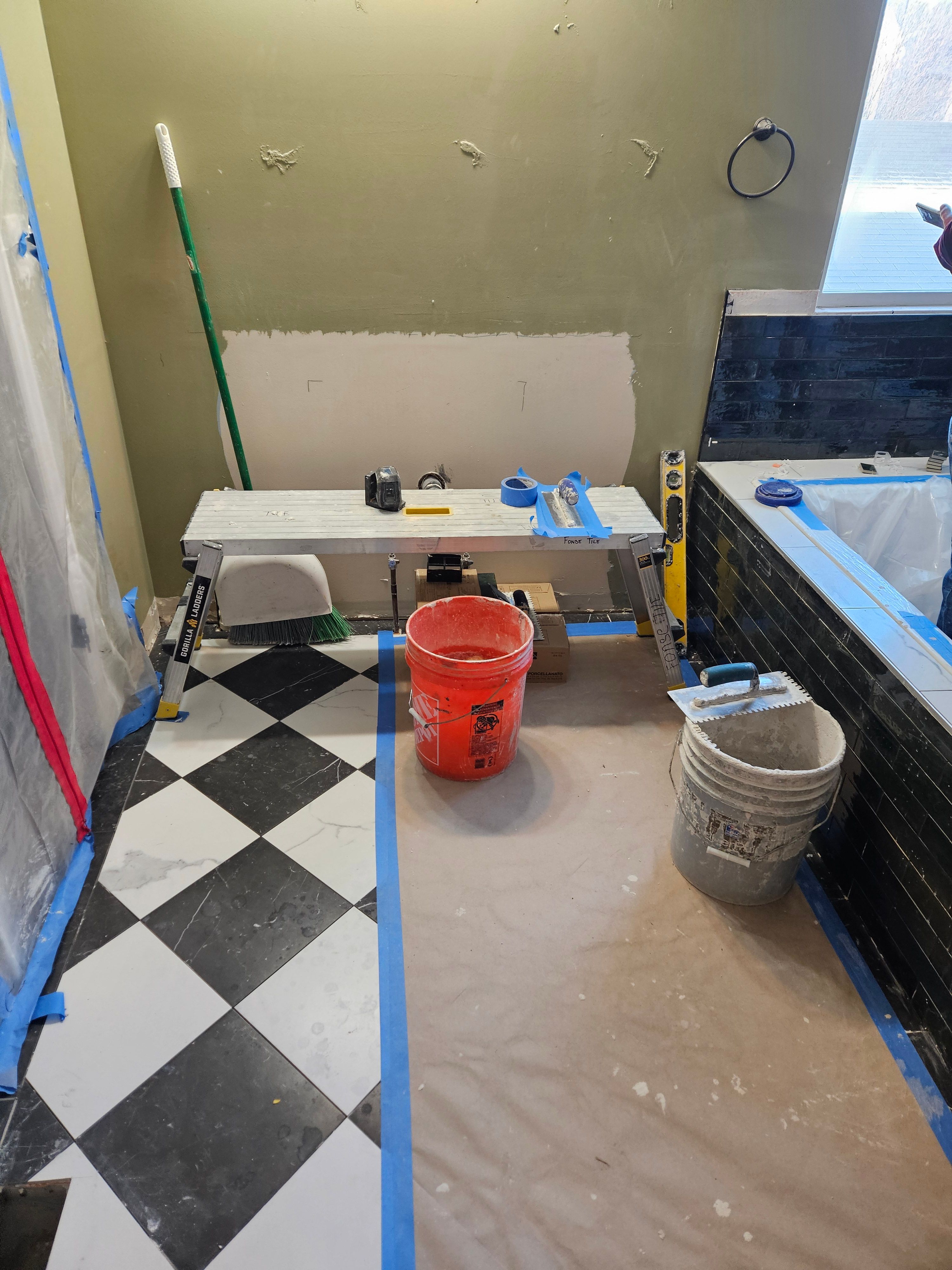 Bathroom floor tile installation in progress in Murray, Utah remodel project.