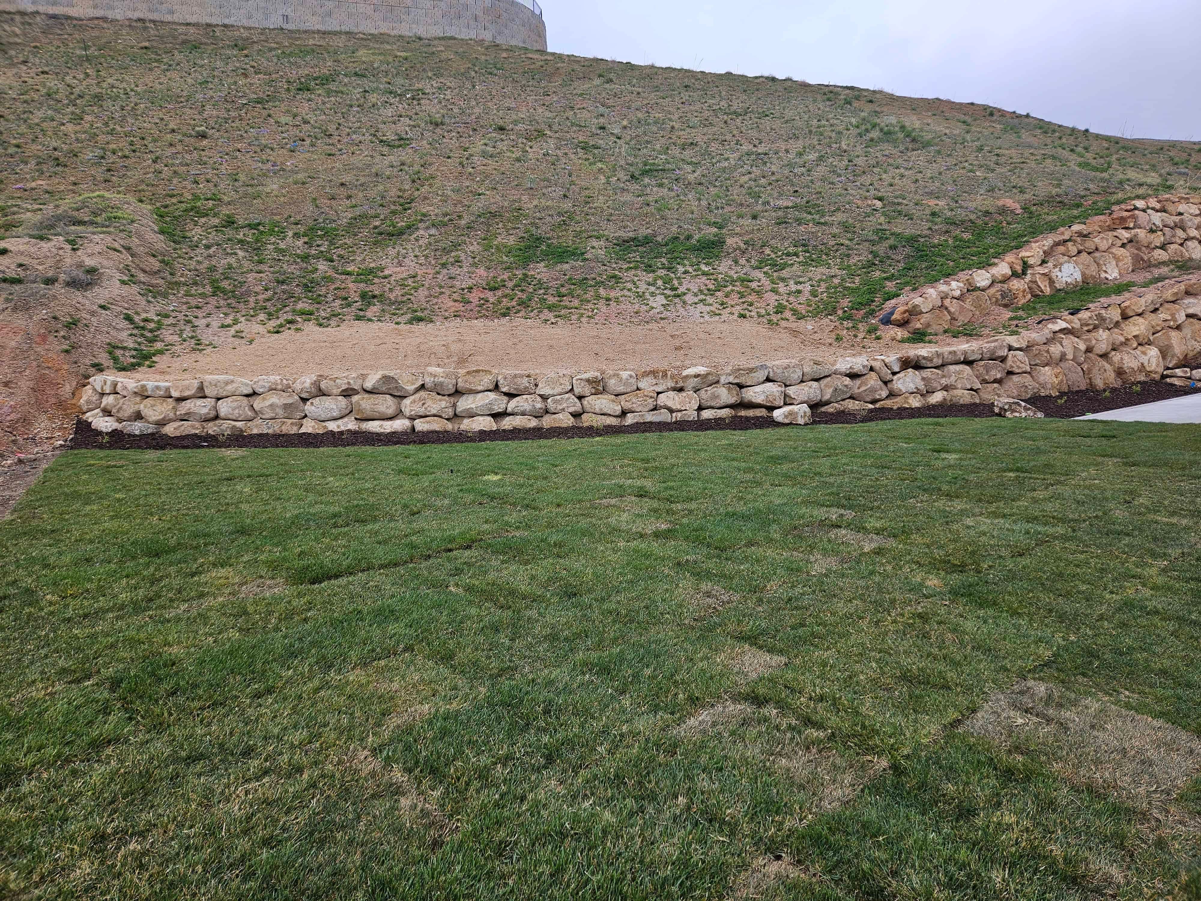 Retaining wall installation in Lehi, Utah backyard landscape project.