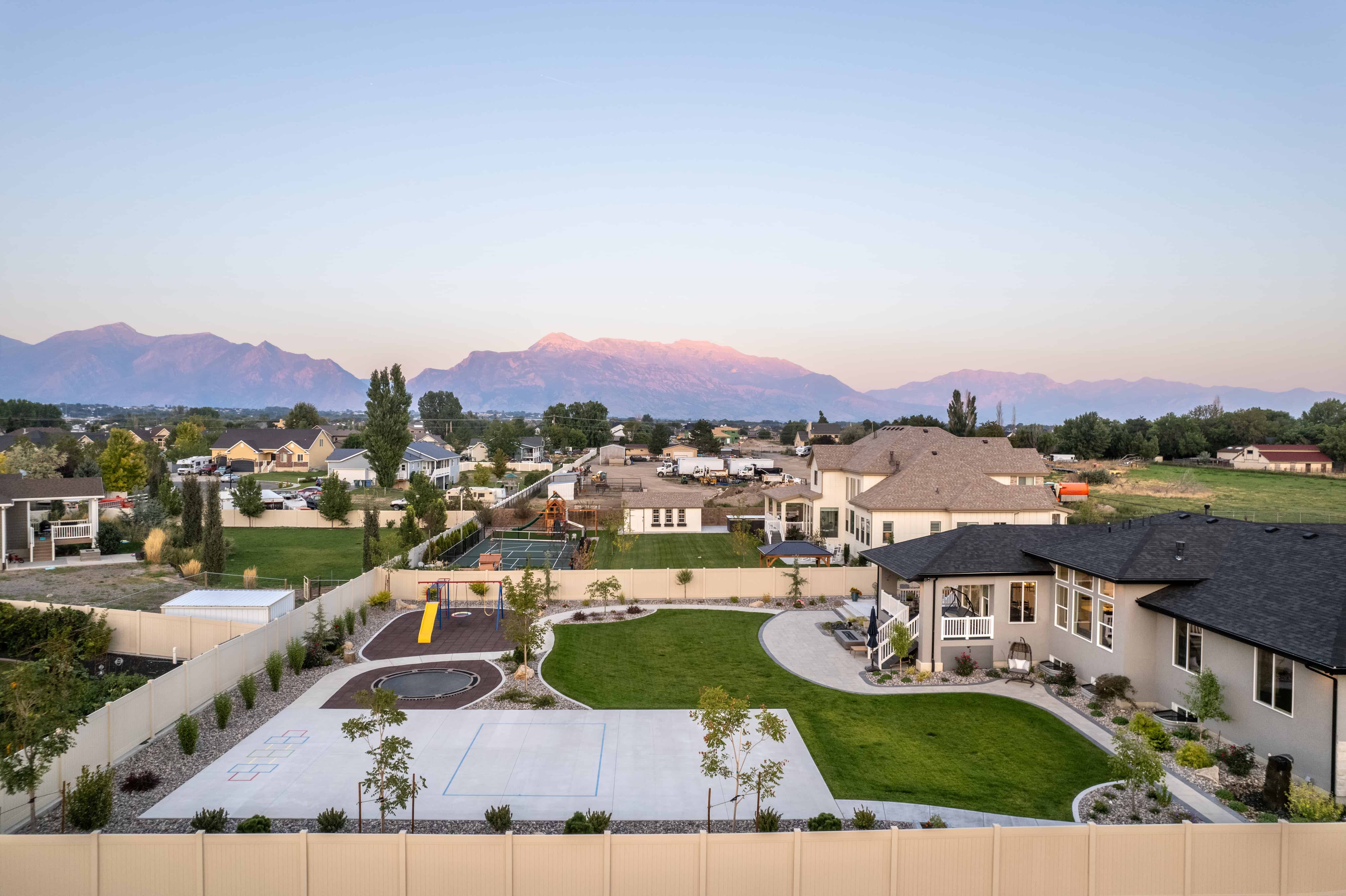A sports court and modern paver patio designed by Pitt Landscape in a Lehi backyard.