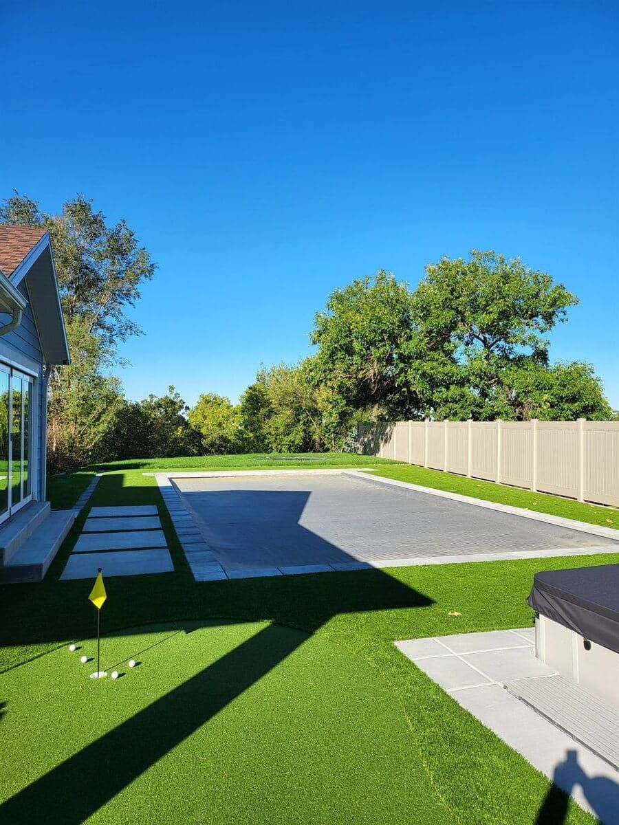 Swimming pool installation with custom landscape design in Sandy, Utah.