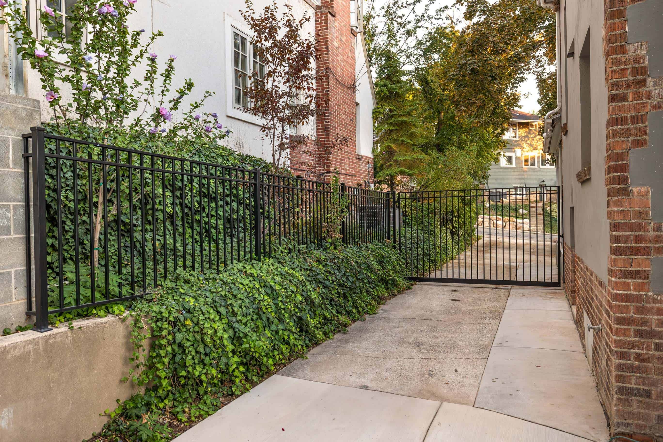 Black metal fence and gate installation in Federal Heights, Utah, part of a broader garage construction project.