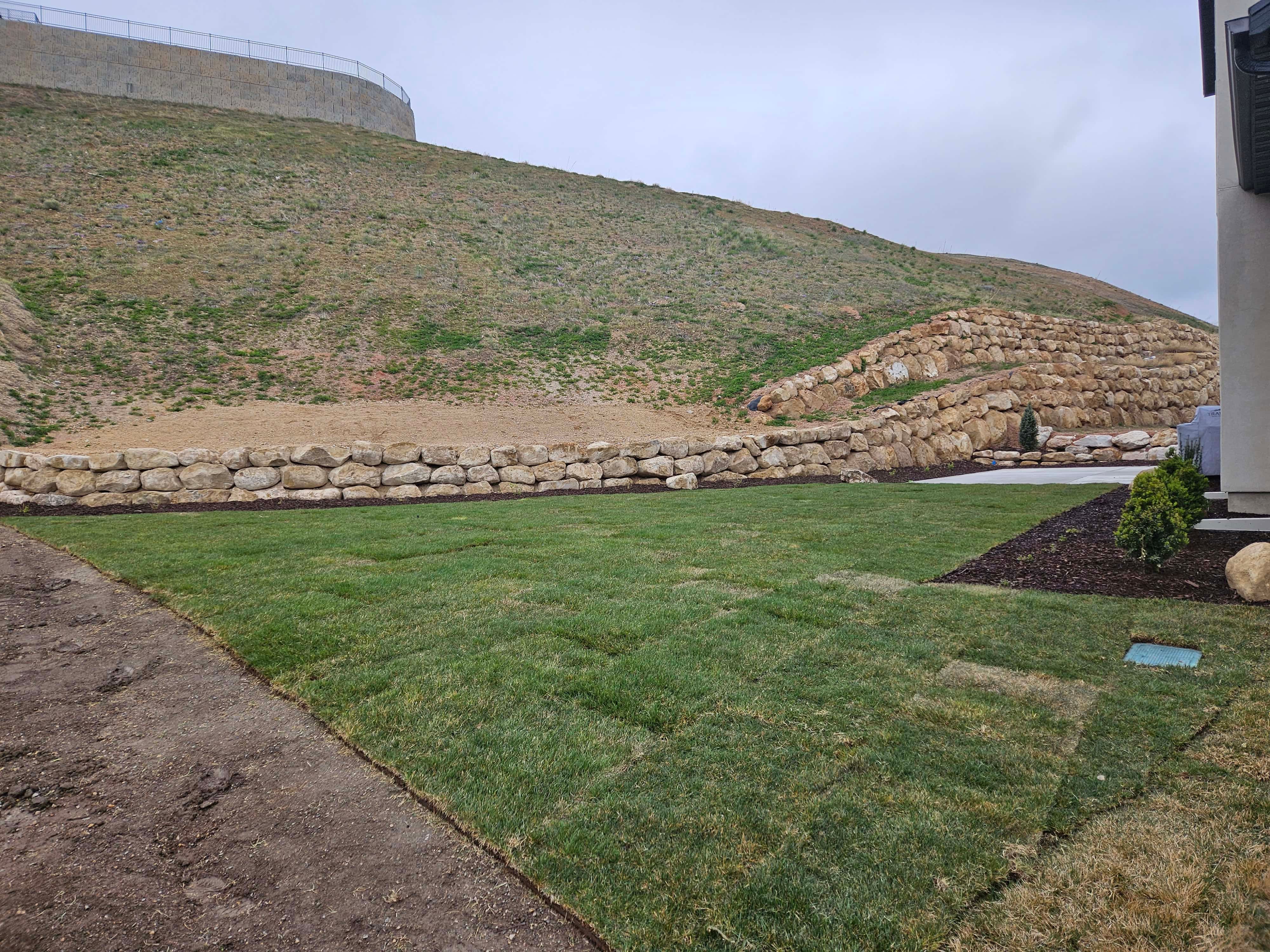 Alternate view of retaining wall in Lehi, Utah landscape installation.