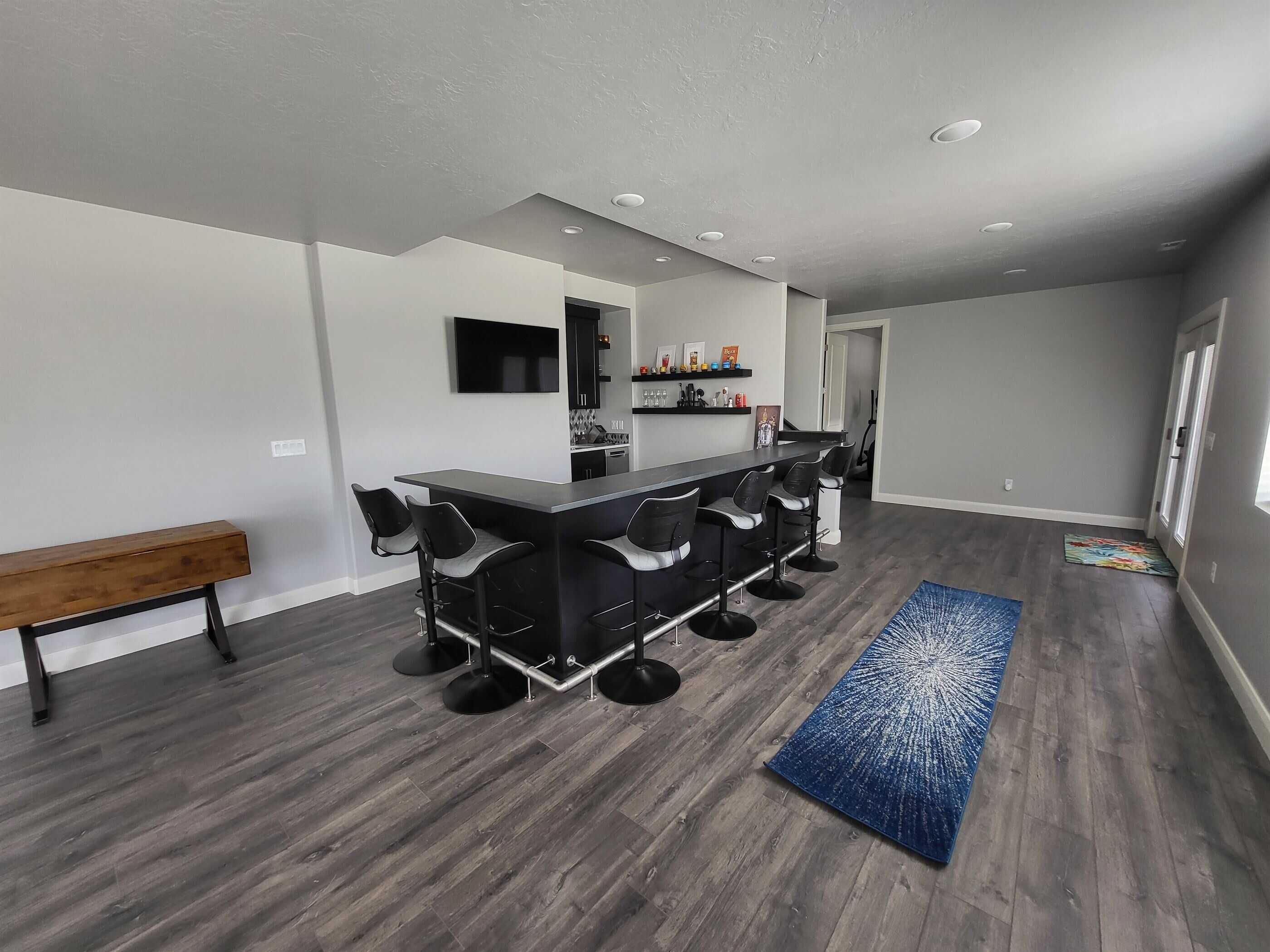 Second angle of custom basement bar with bar seats in a basement remodeling project in Salt Lake City.