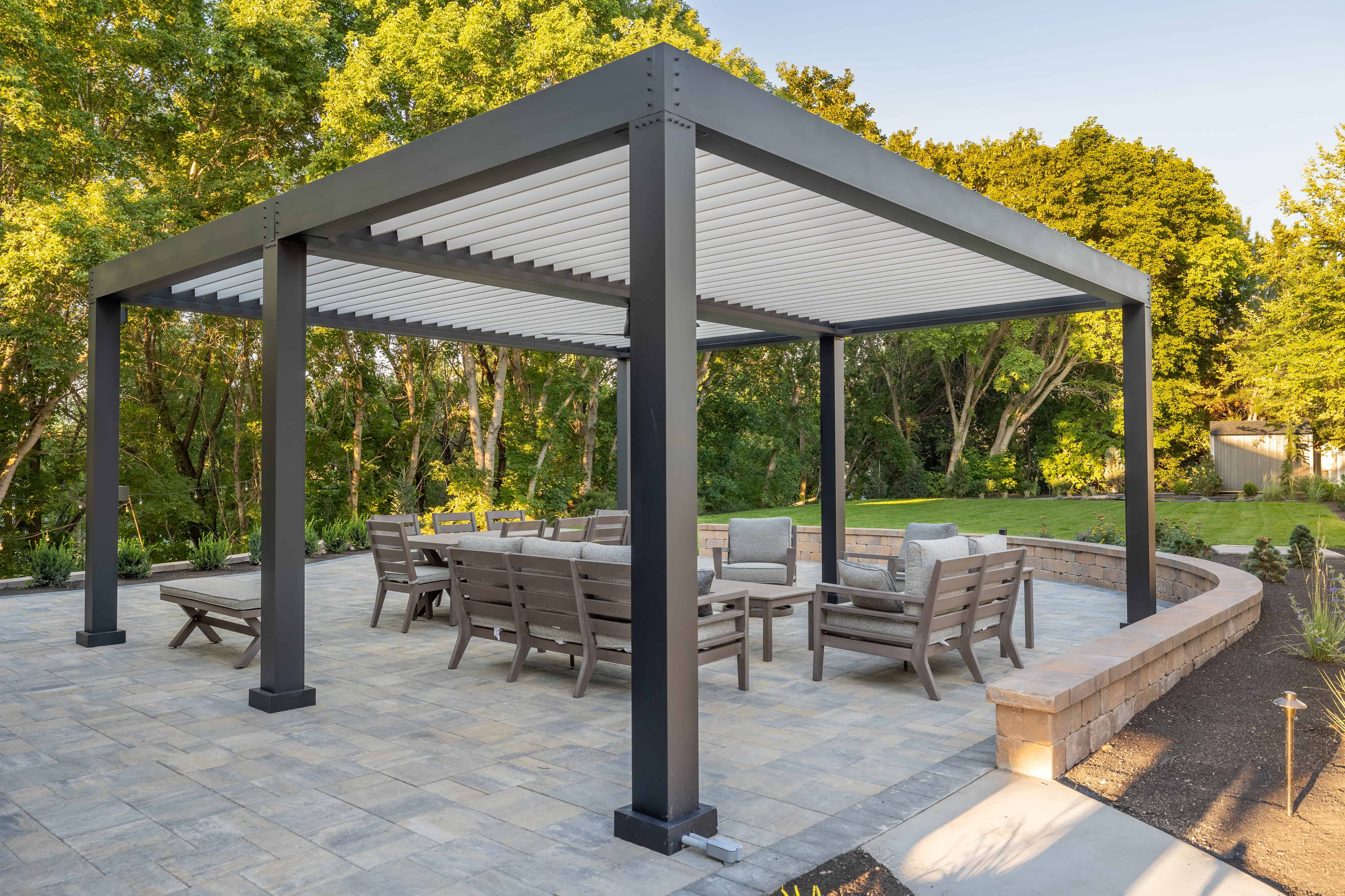 Custom pavers installation patio with shade covering in Murray, Utah by Pitt Landscape & Construction