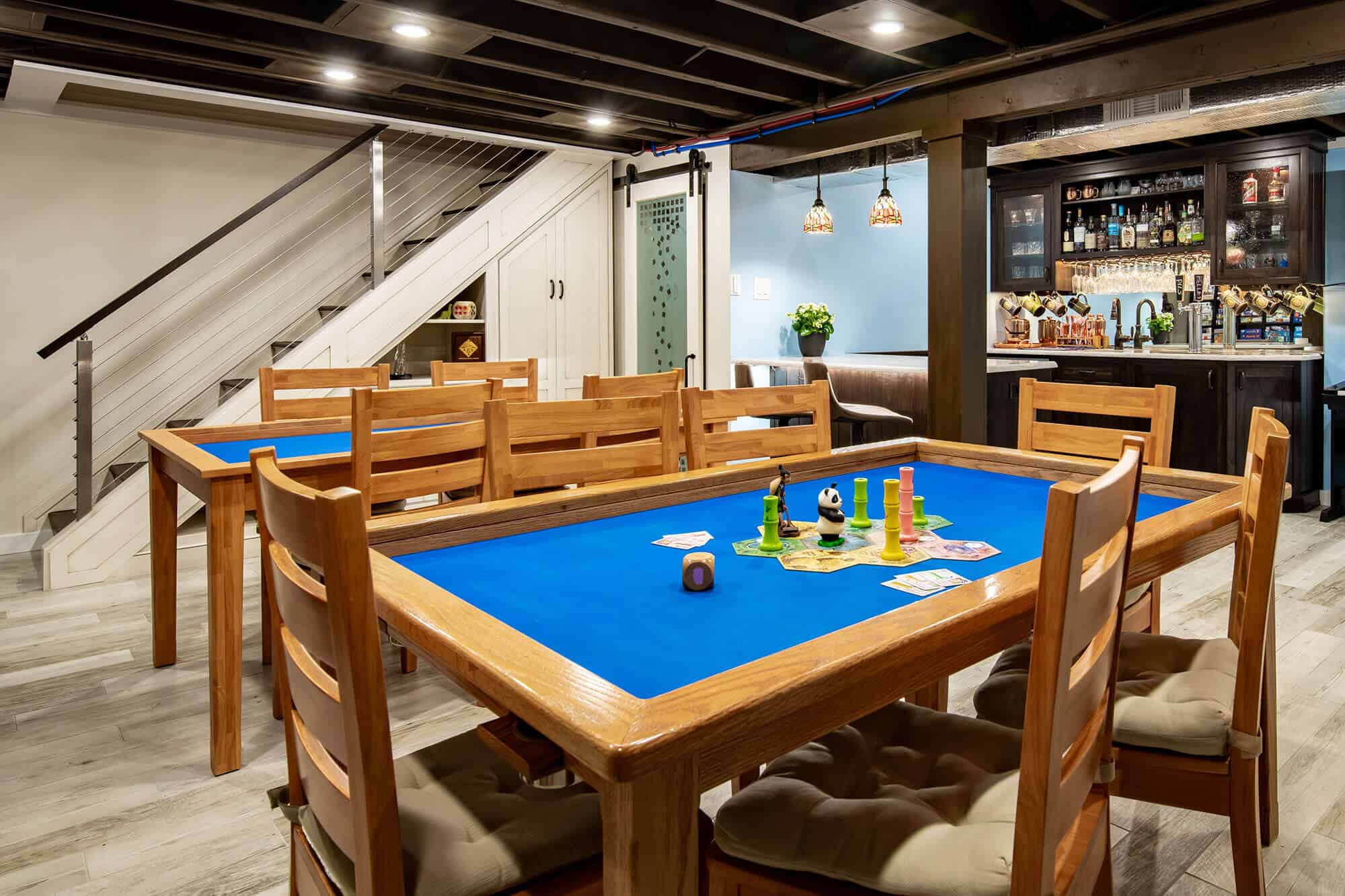 Family room with custom lighting and built-in storage after basement remodeling in Millcreek, Utah.