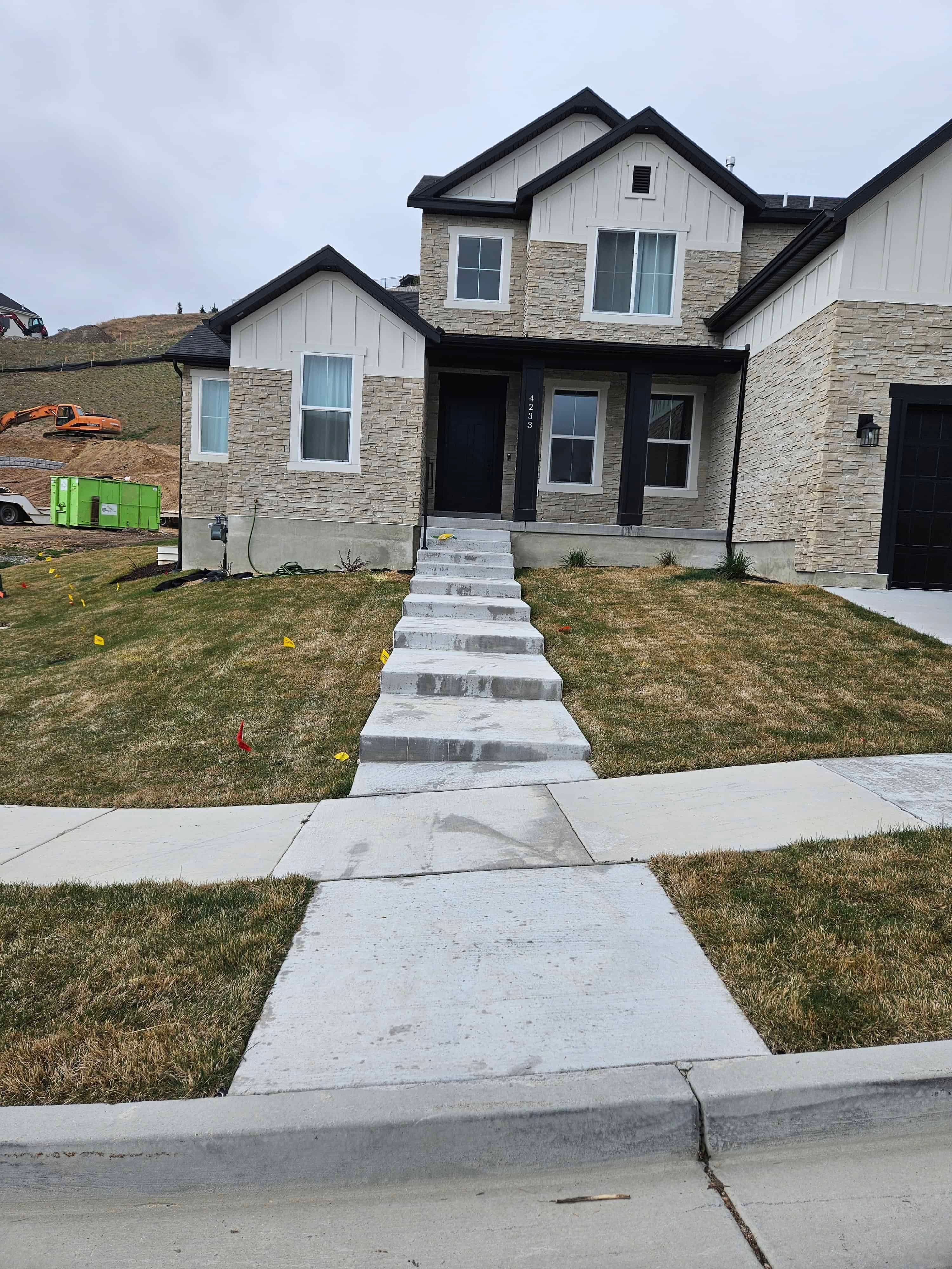 Wide before view of front yard walkway in Lehi, Utah prior to landscape renovation.
