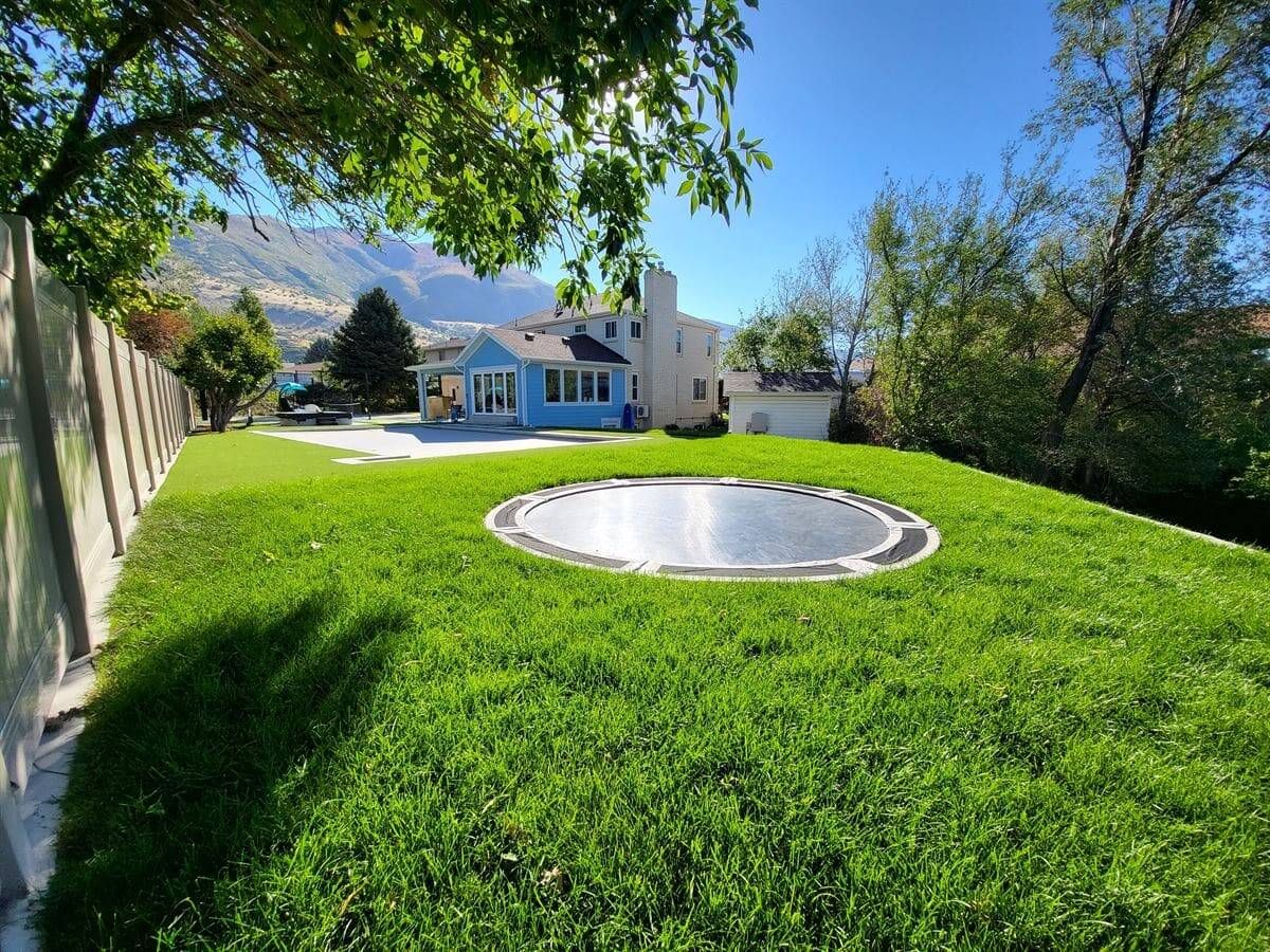 Inground trampoline installation with custom landscaping in Sandy, Utah.