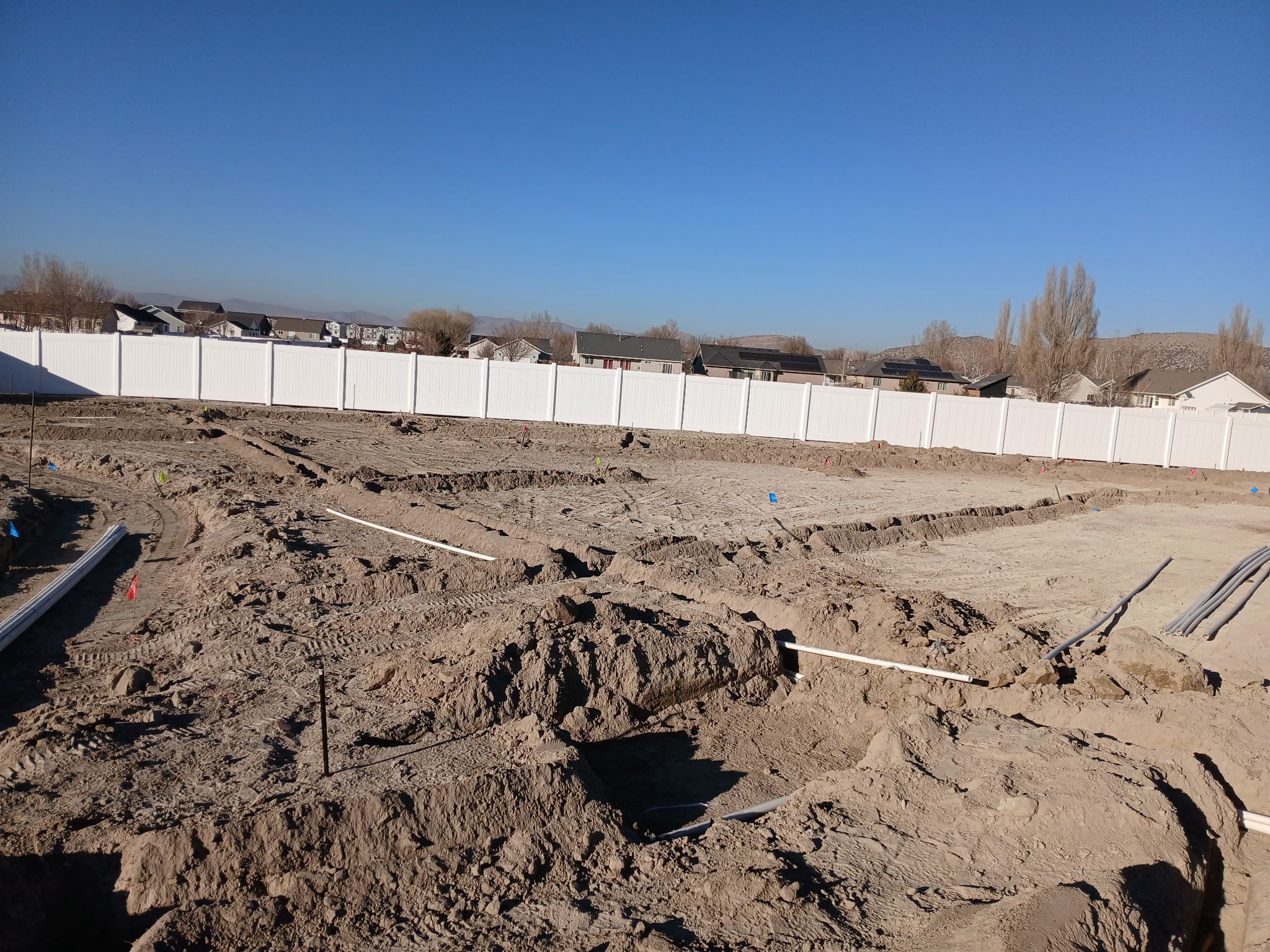 Irrigation trenches and pipe layout during backyard landscape installation