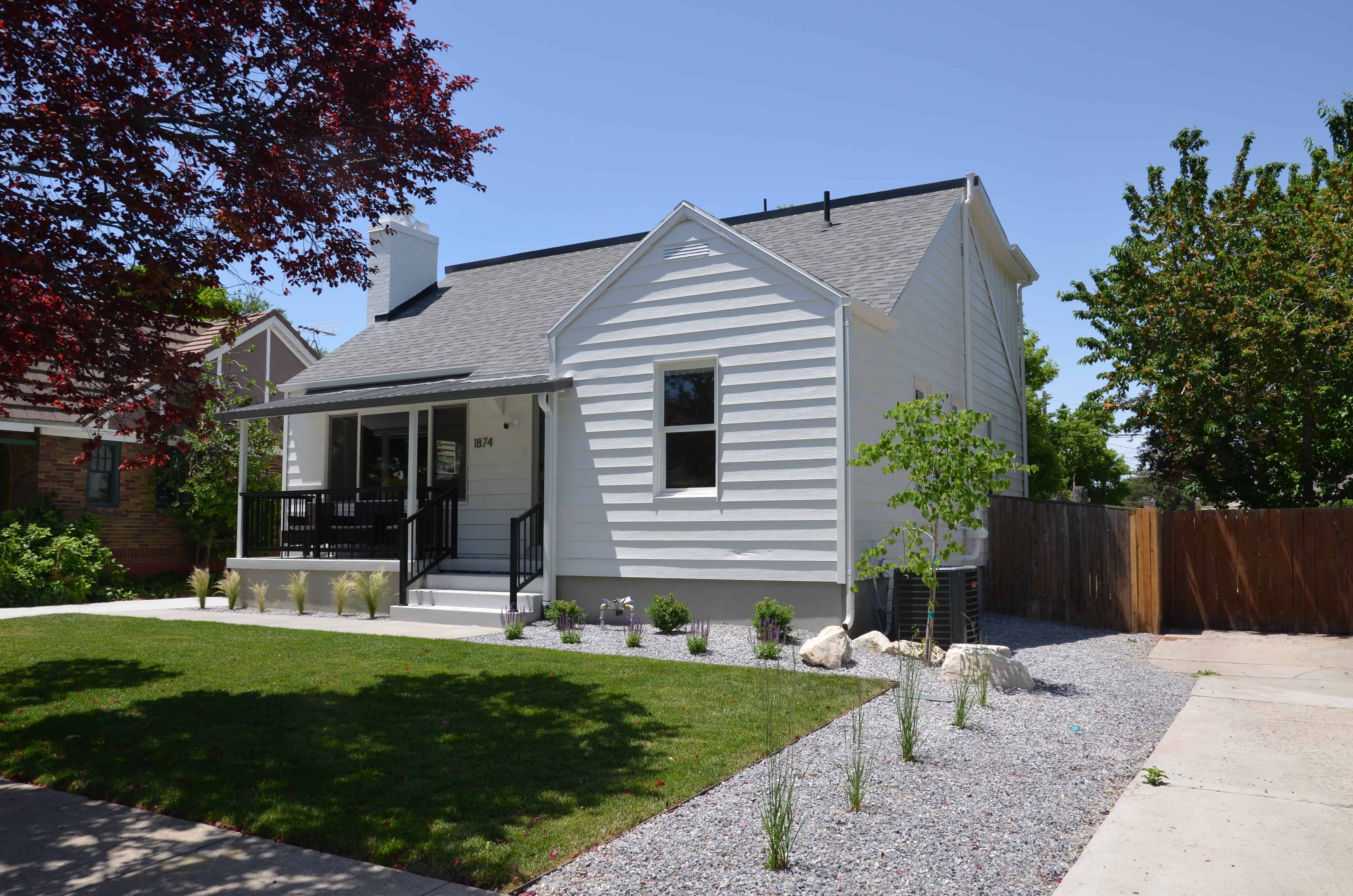 Renovated home exterior with a landscaped front yard and low-water planting bed