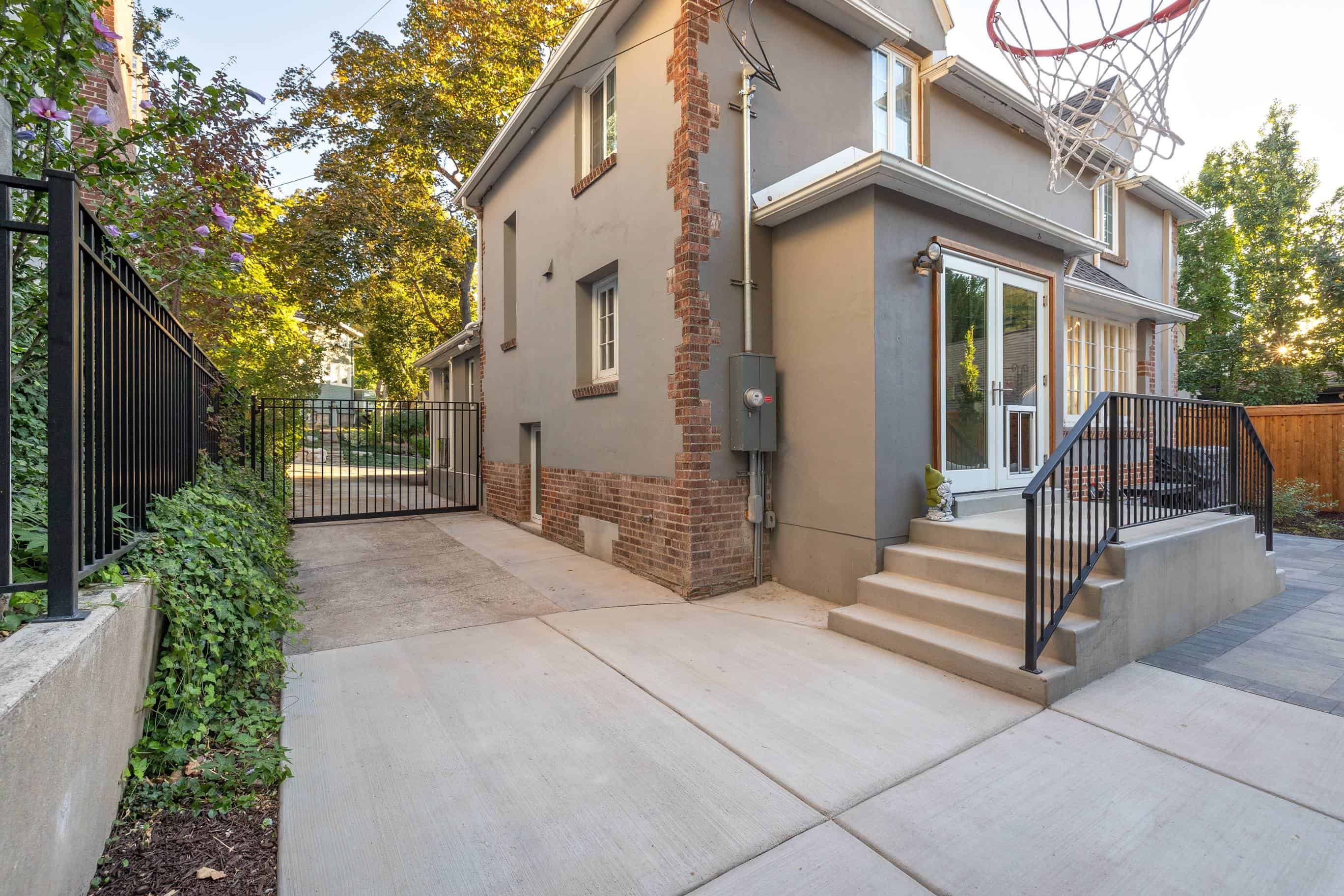Concrete pad and stairs installation with black metal railing in Federal Heights, Utah.
