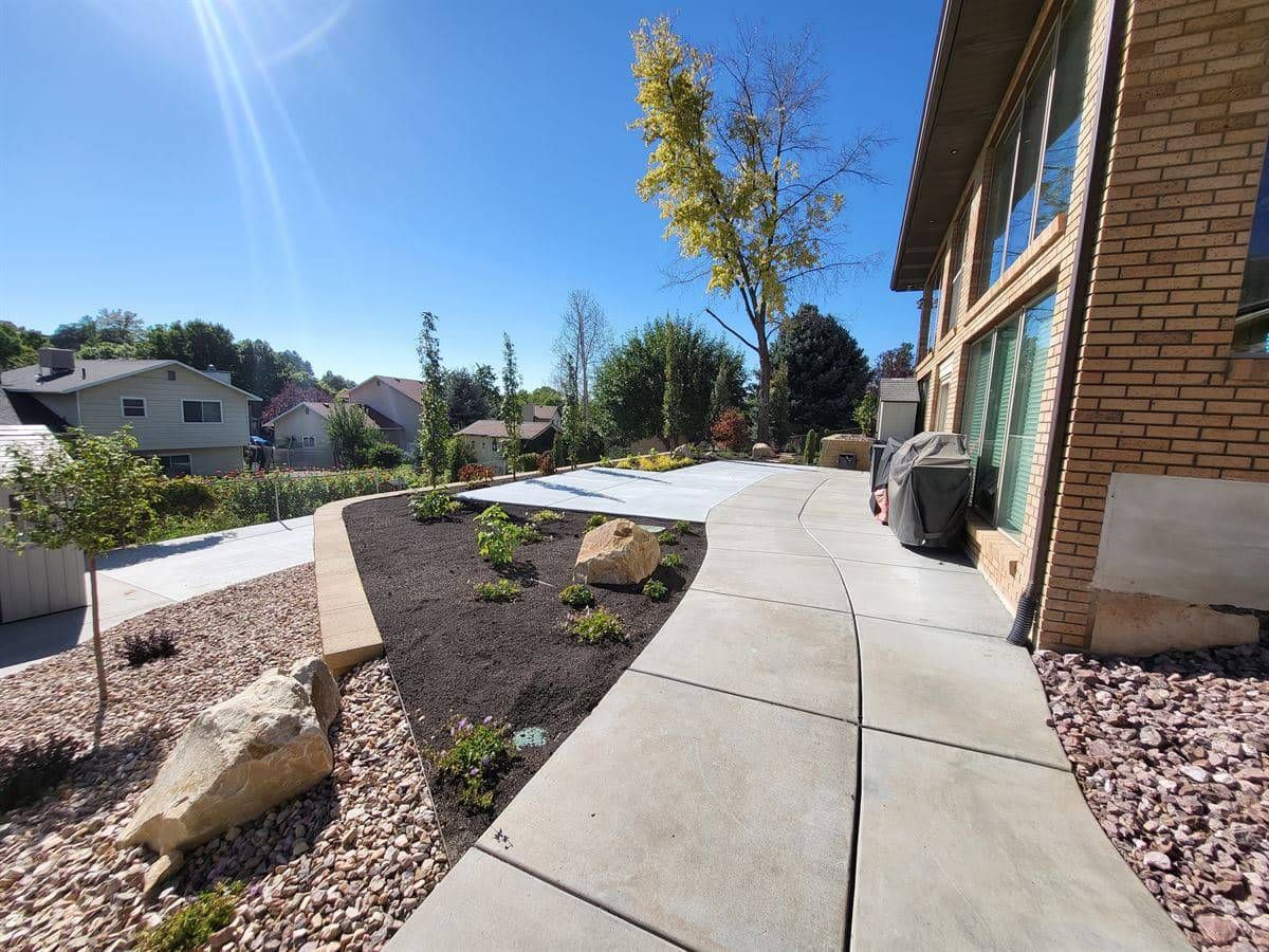 Custom landscape design with a retaining wall in Sandy, Salt Lake City.