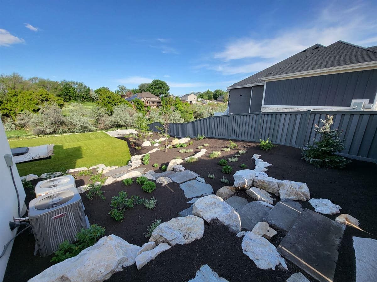 Boulder wall installation in custom landscape design project, Salt Lake City.