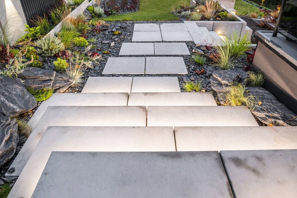 Modern concrete stepping-stone path through a drought-tolerant landscaped garden