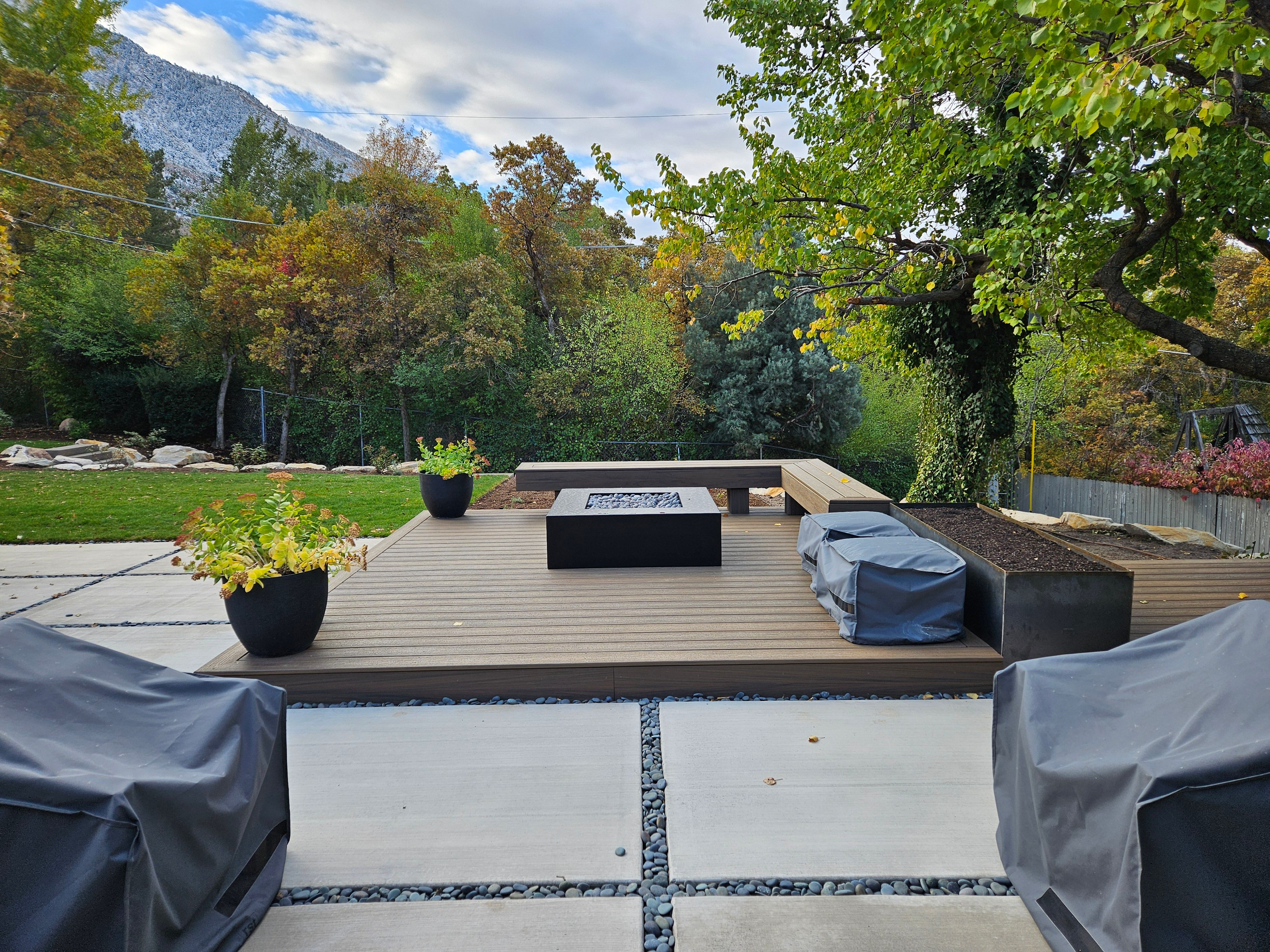 Trex composite deck with fire pit feature in Holladay backyard.