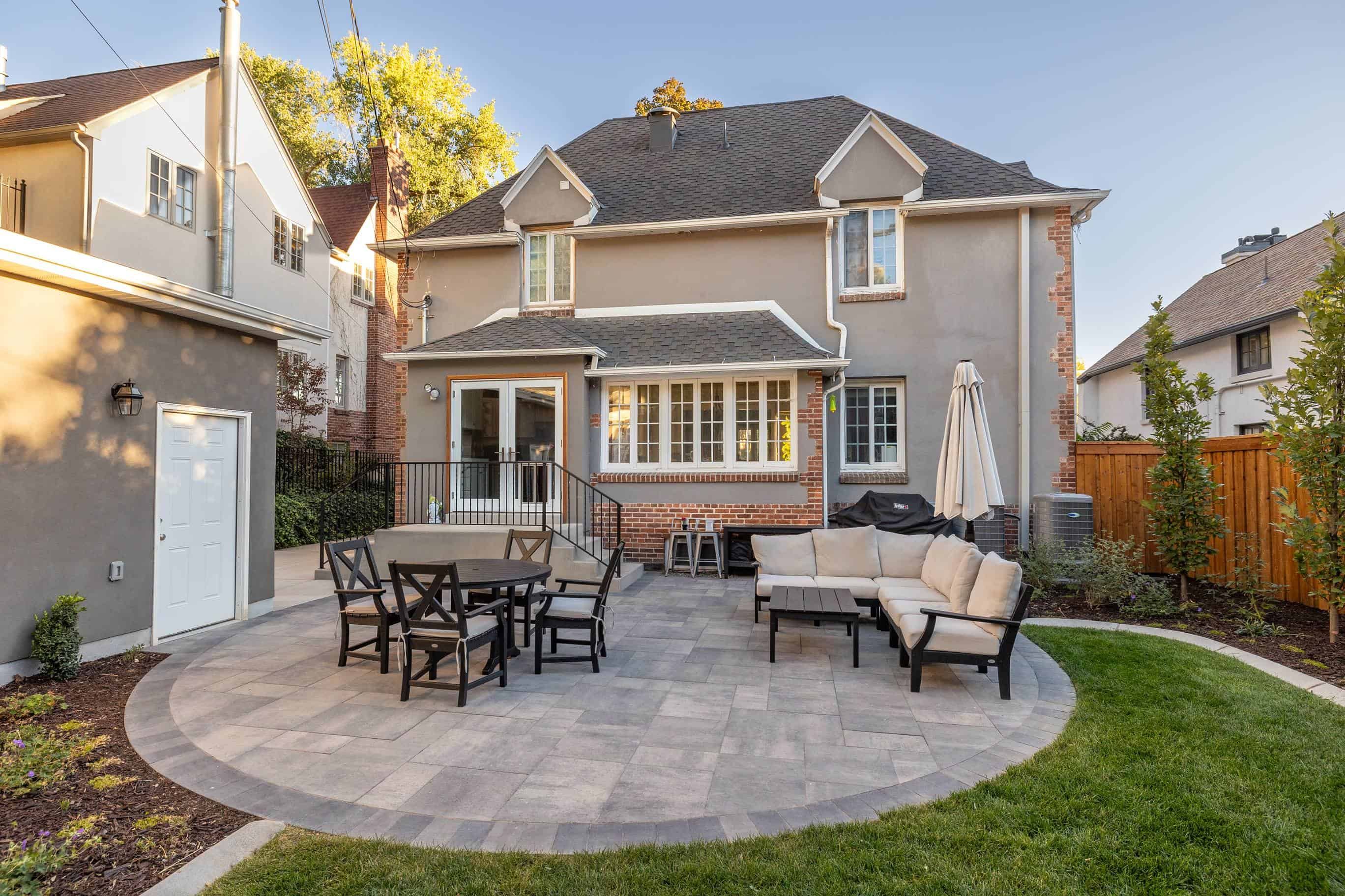 Alternate view of the custom gray pavers patio looking at the back of the home in Federal Heights, Utah.