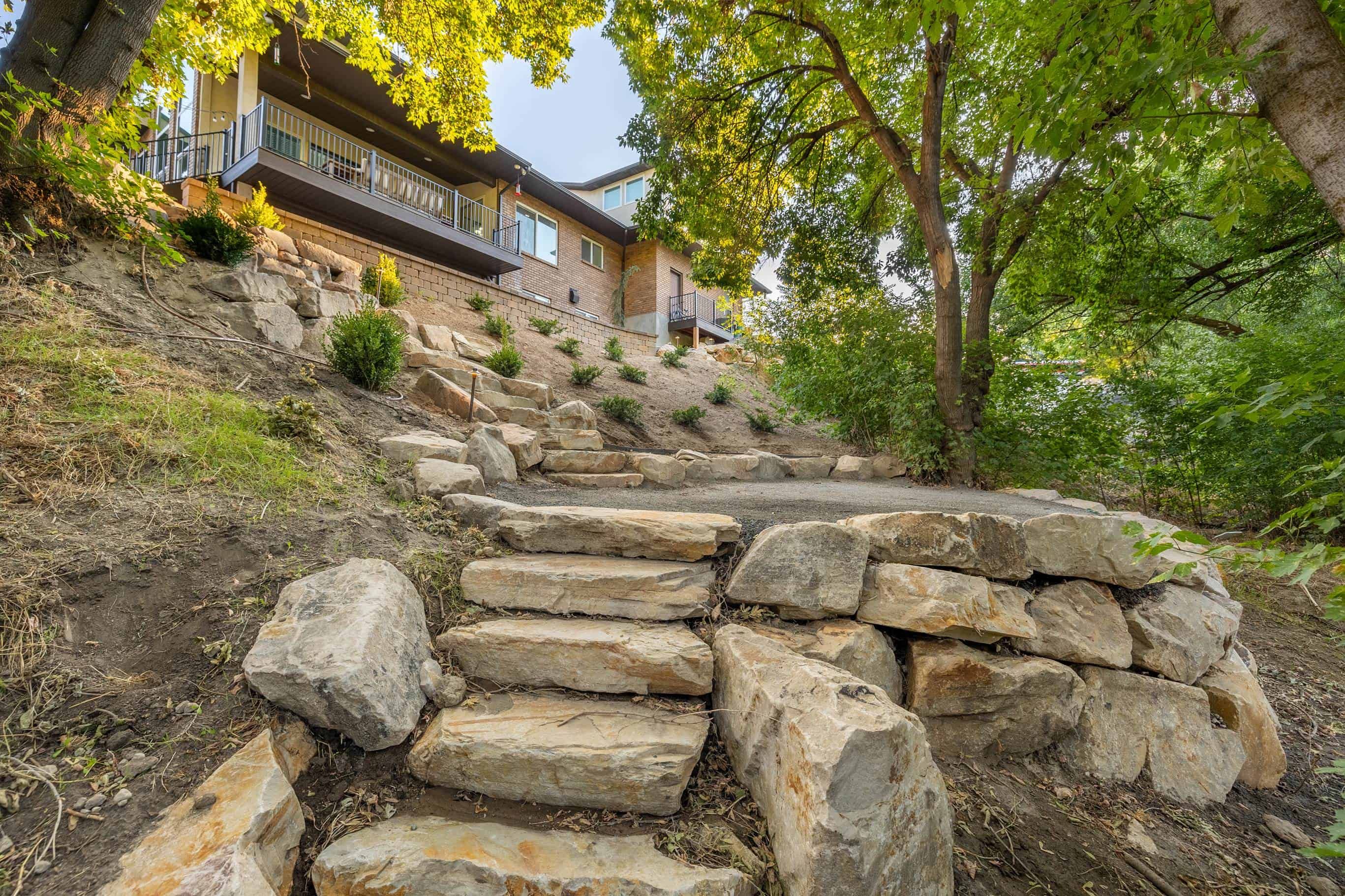 Boulder retaining wall on a steep incline in Murray, Utah.