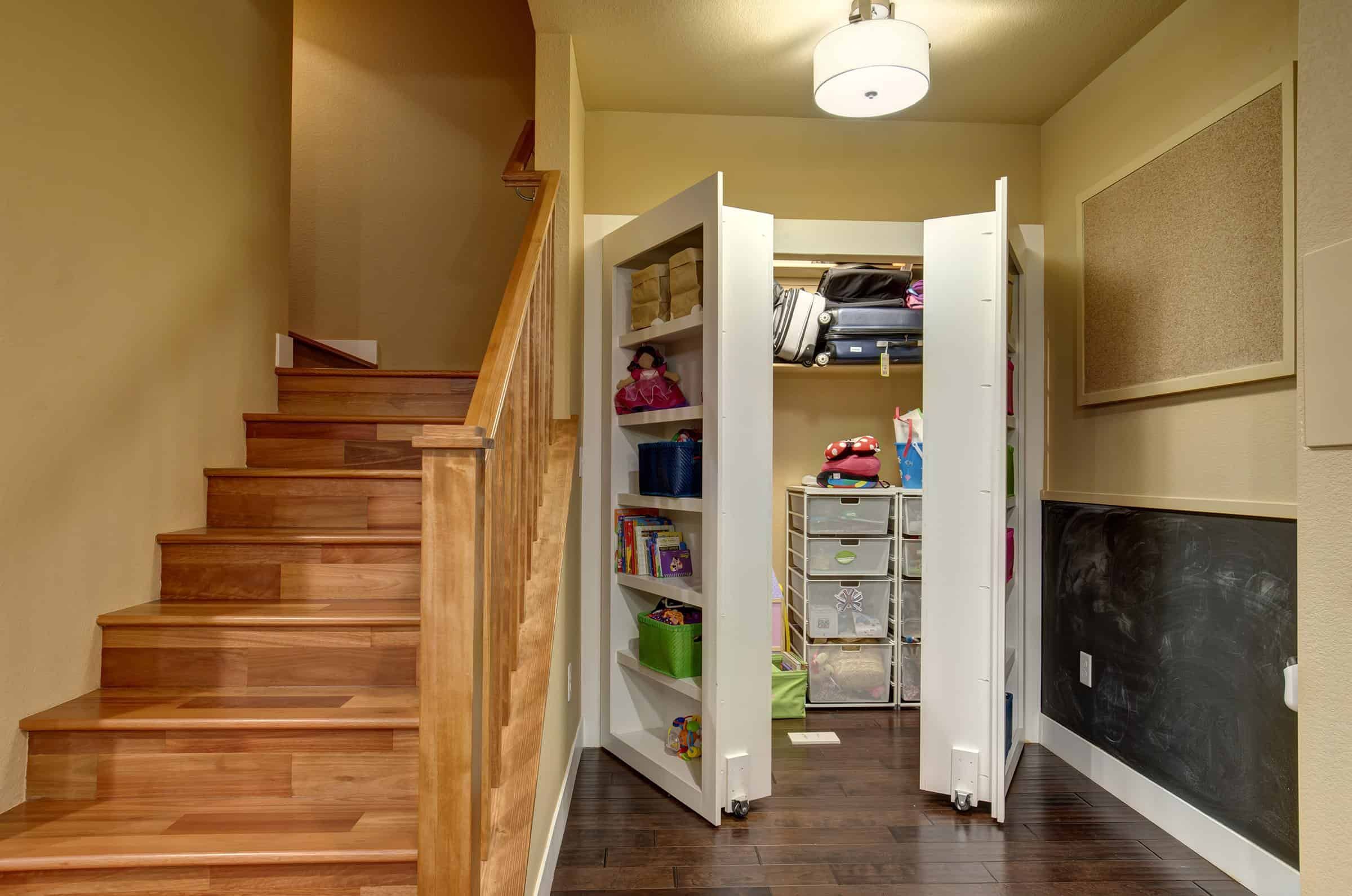 Hidden storage room behind a custom-built bookcase in a finished basement in Sandy, Utah.